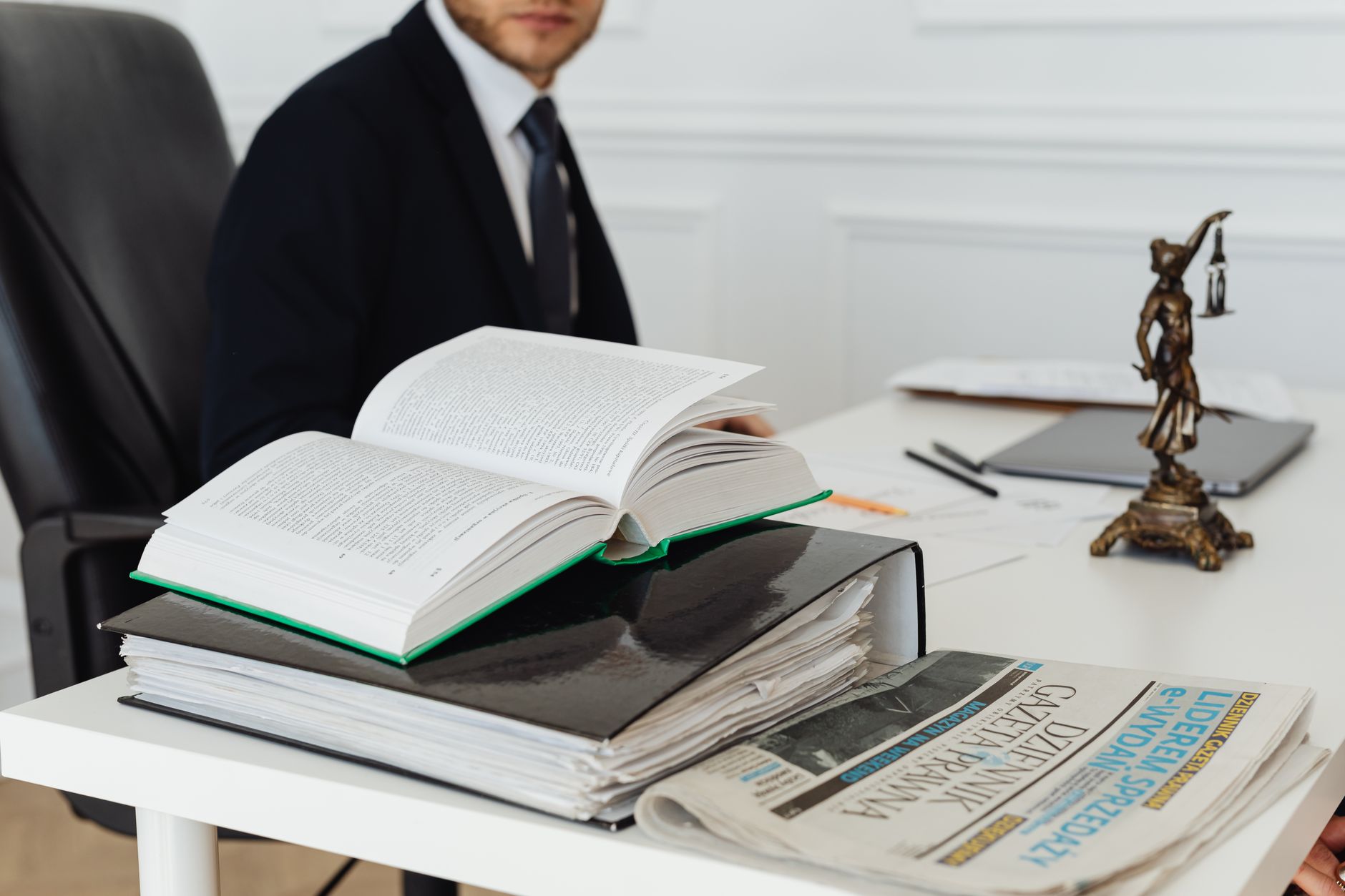 Legal documents and a gavel on a desk representing a corporate lawsuit
