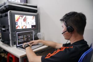 A gaming and live streaming desk setup with microphone and monitor
