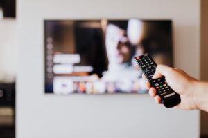 Person browsing a streaming service on a modern television screen