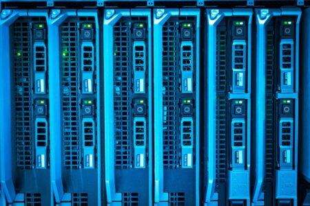 OpenAI and Anthropic Cut Prices as Flock Surveillance Rules Shift Rows of glowing data servers representing AI infrastructure and cloud computing costs