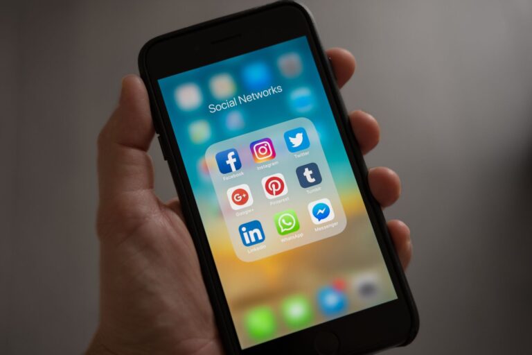 iPhone 15 in 2026: Bargain Buy or a Step Too Far Back? Person holding an iPhone against a neutral background