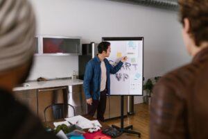 Founder Who Raised $1B Tells Startups What VCs Actually Measure Founders presenting financial data during a startup pitch meeting with investors