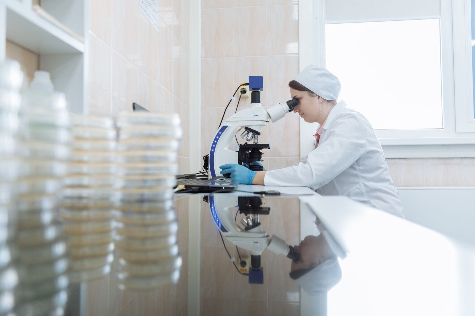 Researcher working in a pharmaceutical laboratory examining molecular drug candidates