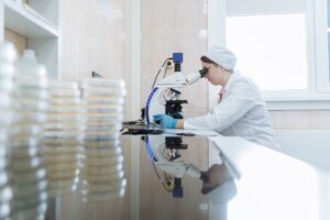 AI Wrote the Drug. Humans Filed the Patent. Researcher working in a pharmaceutical laboratory examining molecular drug candidates