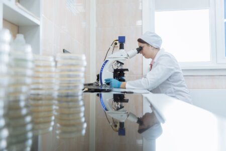 AI Wrote the Drug. Humans Filed the Patent. Researcher working in a pharmaceutical laboratory examining molecular drug candidates