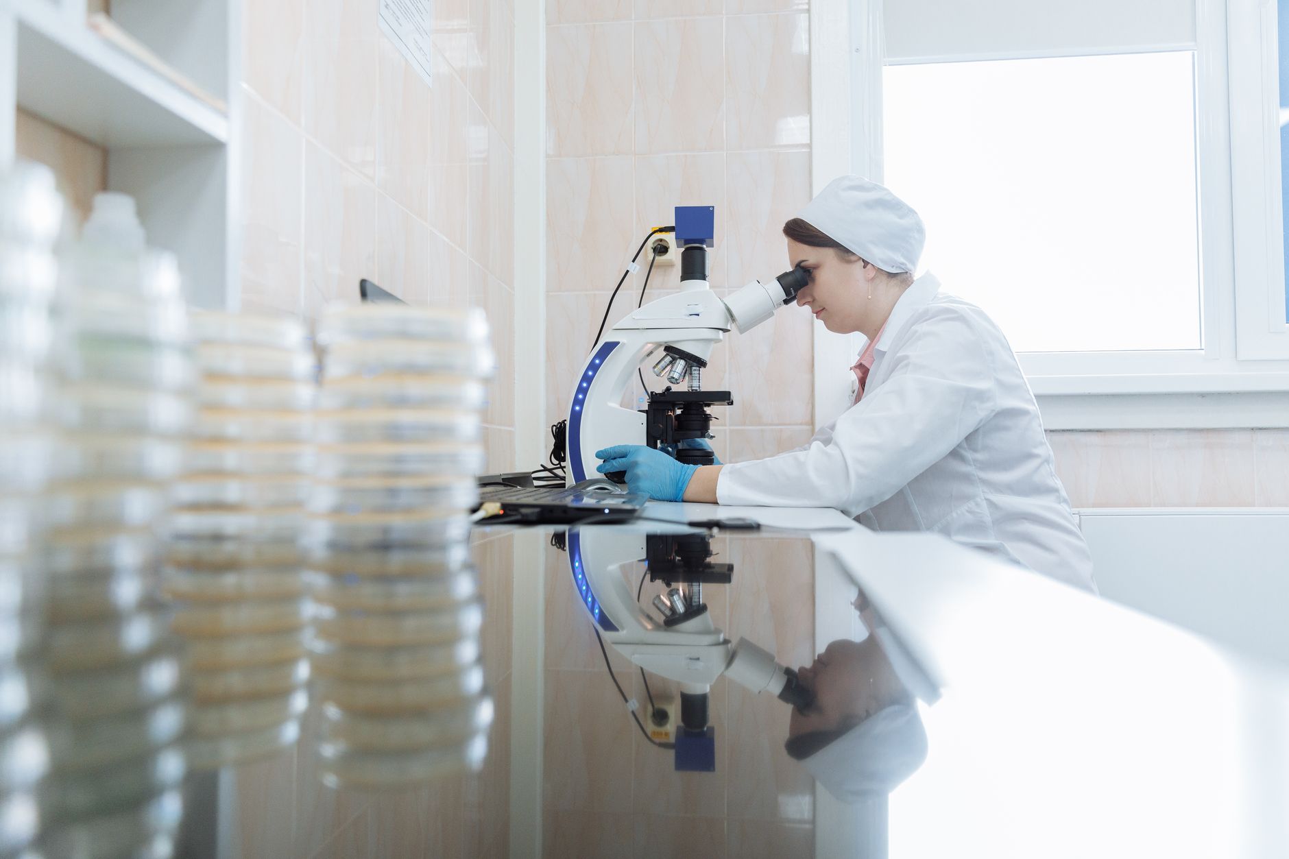 Researcher working in a pharmaceutical laboratory examining molecular drug candidates