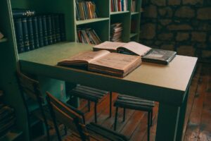 AI Trained on Copyrighted Books: Authors Never Agreed to This Stacks of open books in a library representing copyrighted literary works used in AI training