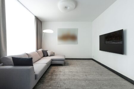 Large flat-screen TV mounted on a white living room wall