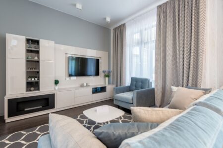 Your 4K TV May Not Be Showing 4K Right Now A modern 4K television mounted in a living room displaying a home screen menu