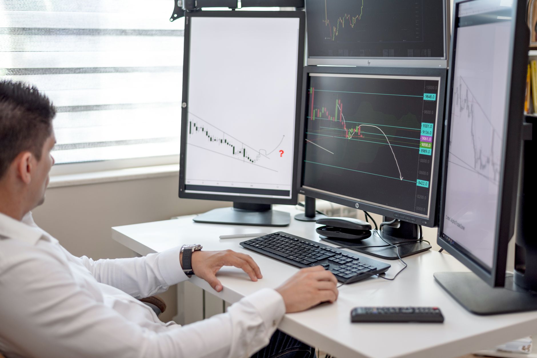 Security analyst working at a computer reviewing threat intelligence data