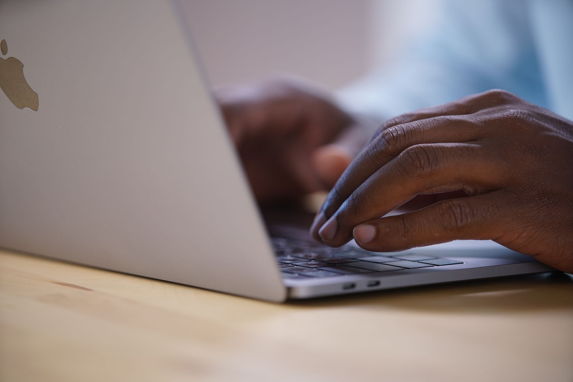 User comparing AI assistant responses on a laptop computer