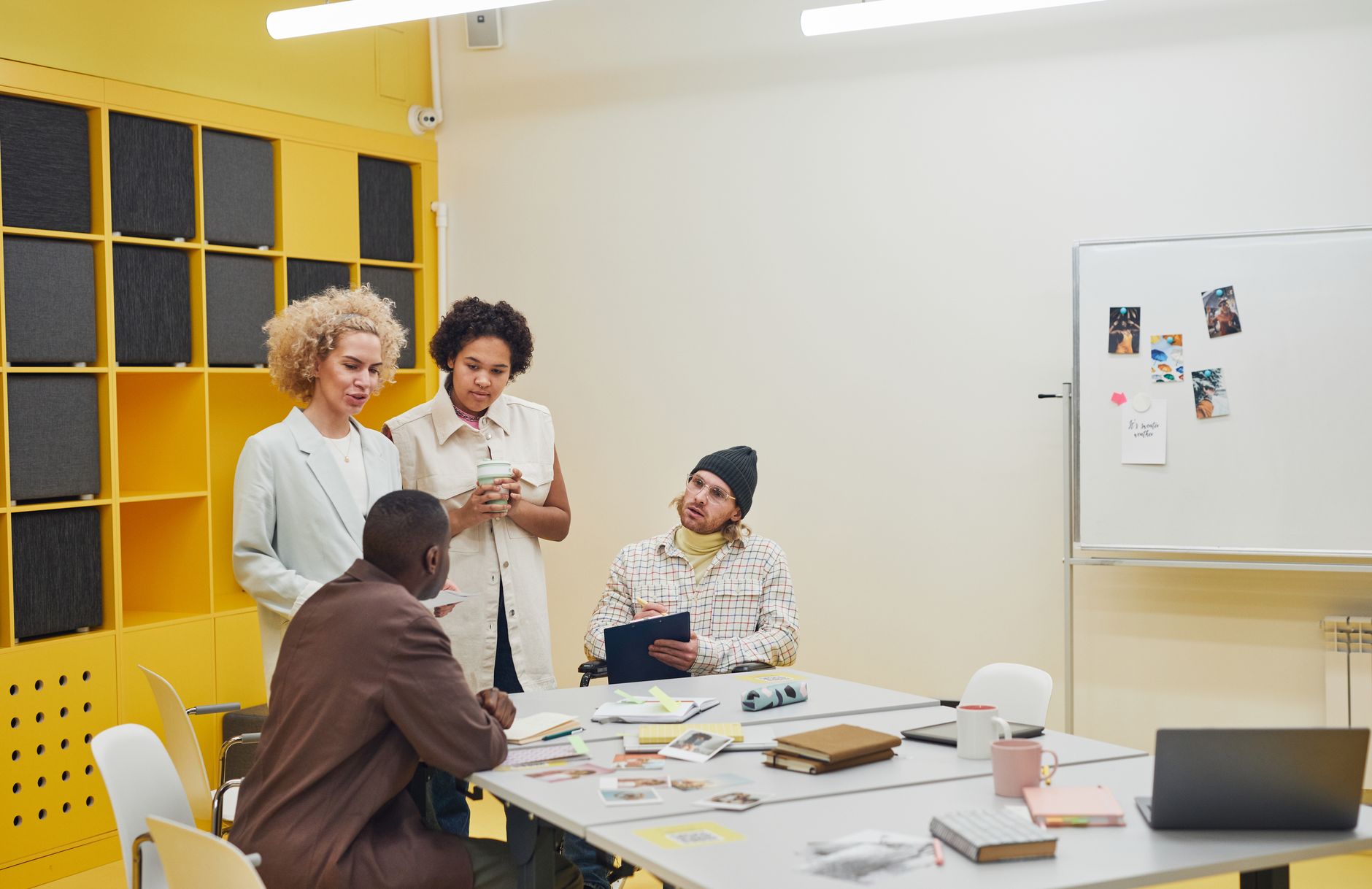 People in a small startup office discussing business strategy
