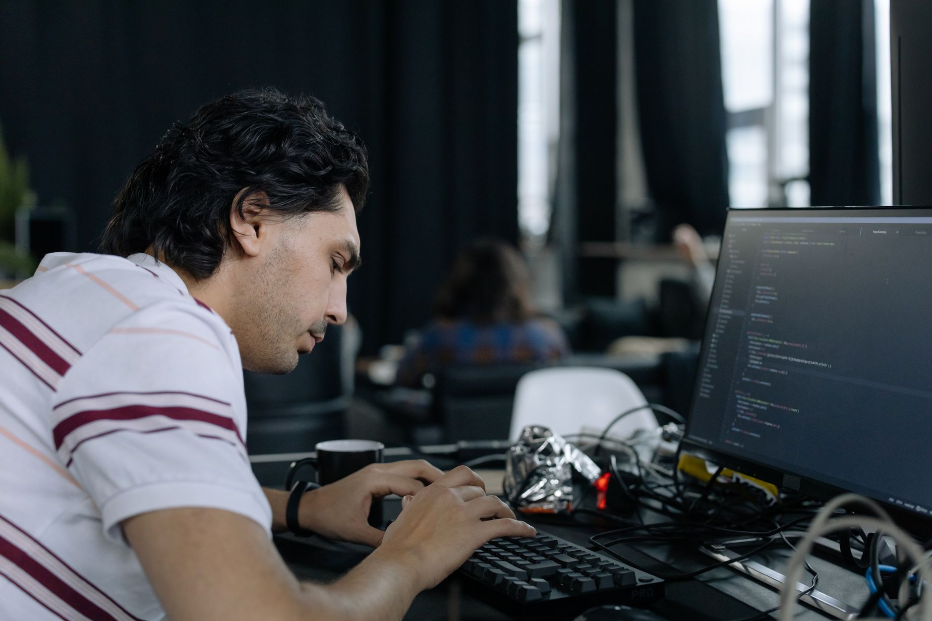 Developer working at a computer during AI model training and testing