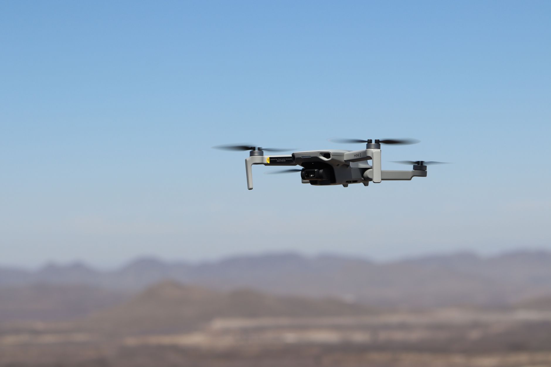 Military-style drone in flight representing the growing unmanned aerial vehicle threat