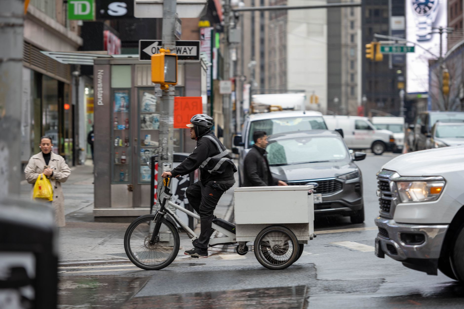 A cargo e-bike loaded with delivery packages on an urban road