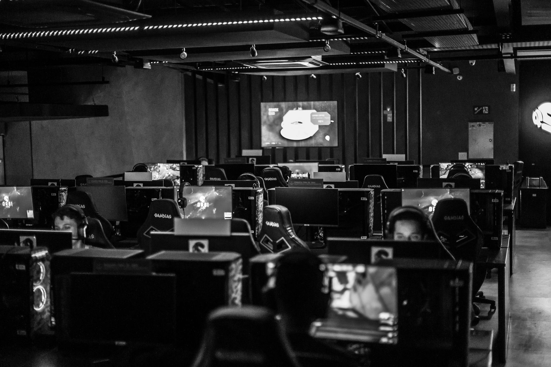 Esports arena audience watching a competitive gaming event on large screens