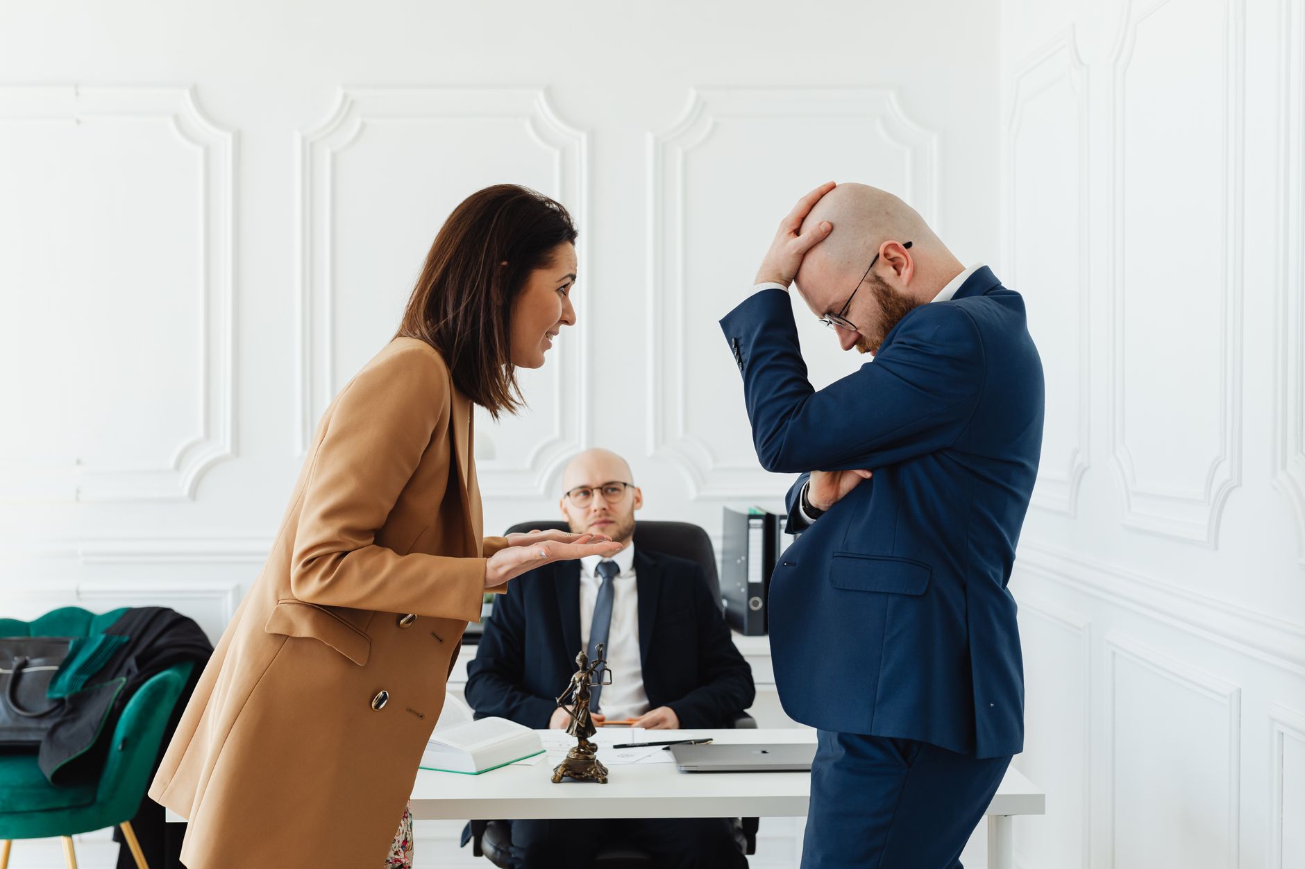 Two professionals across a table in a tense business negotiation