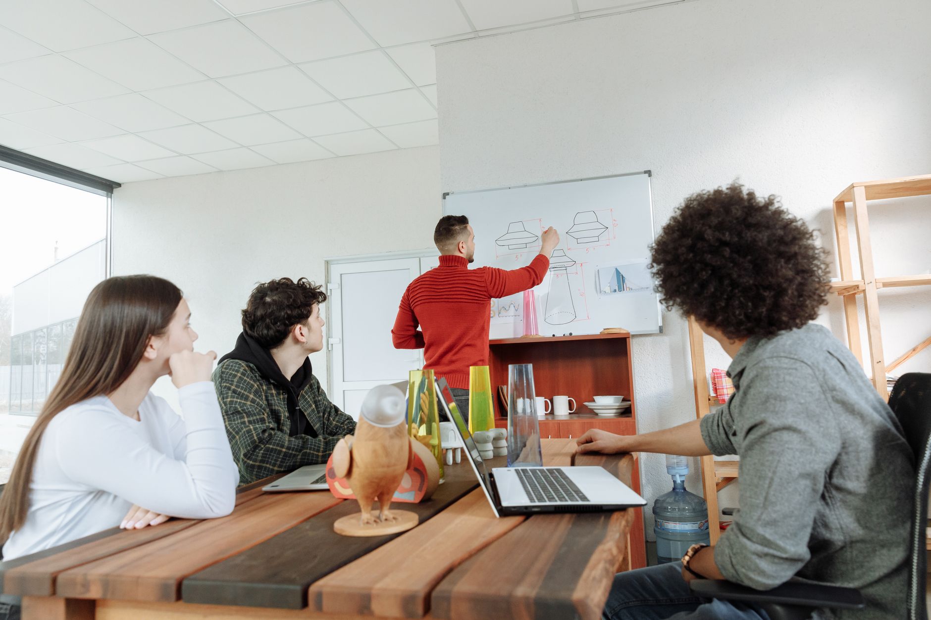 Private startup office with people gathered around a conference table