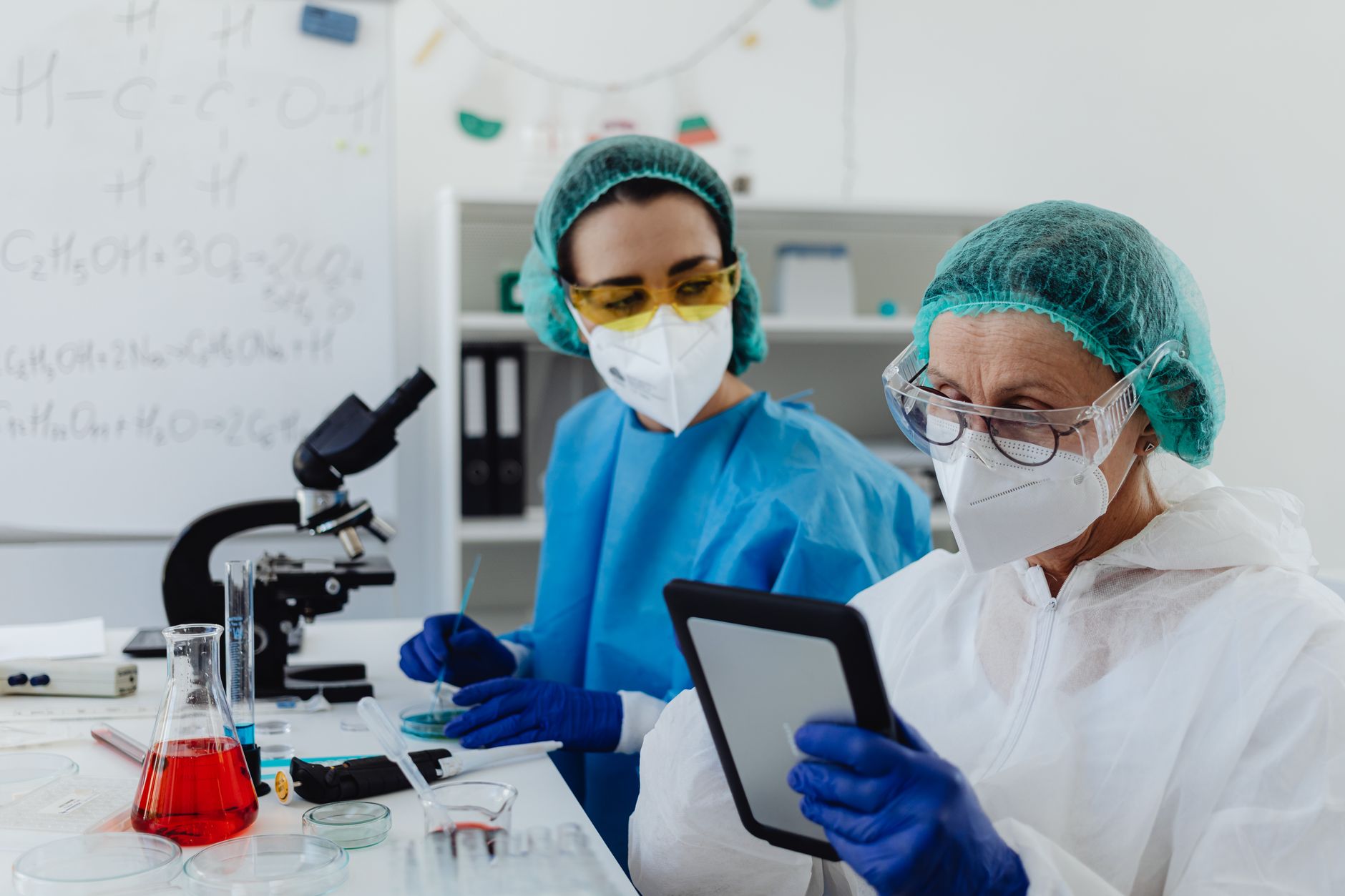 Scientist working with biological datasets on multiple computer monitors