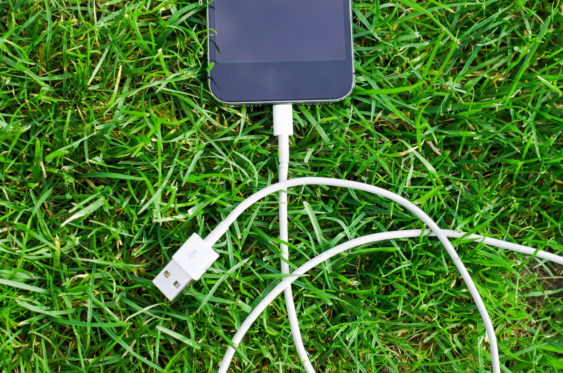 Smartphone plugged into a USB-C charging cable on a desk