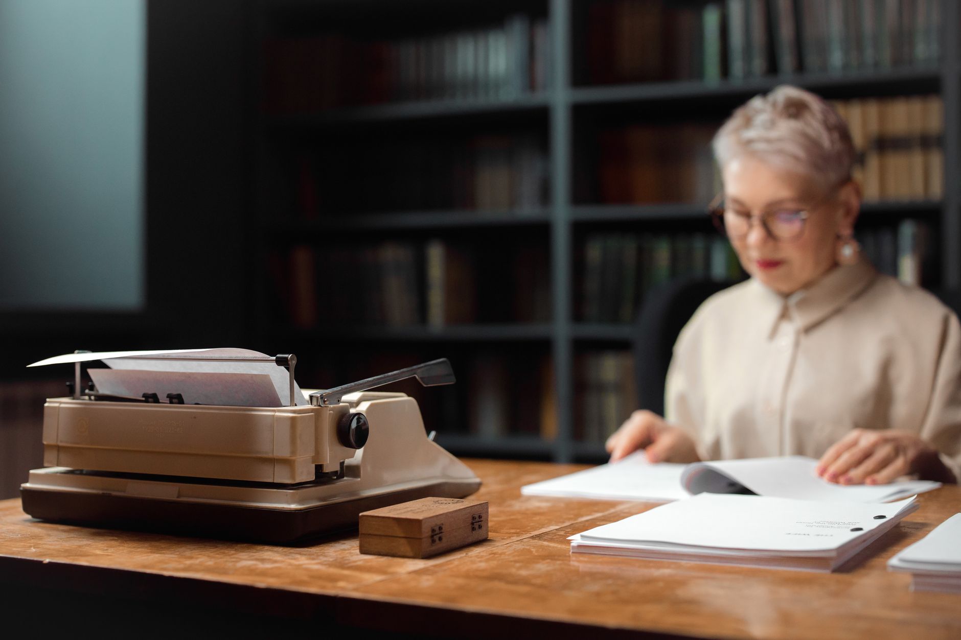 Writer working at a desk representing authors whose published works were used without consent to train AI models