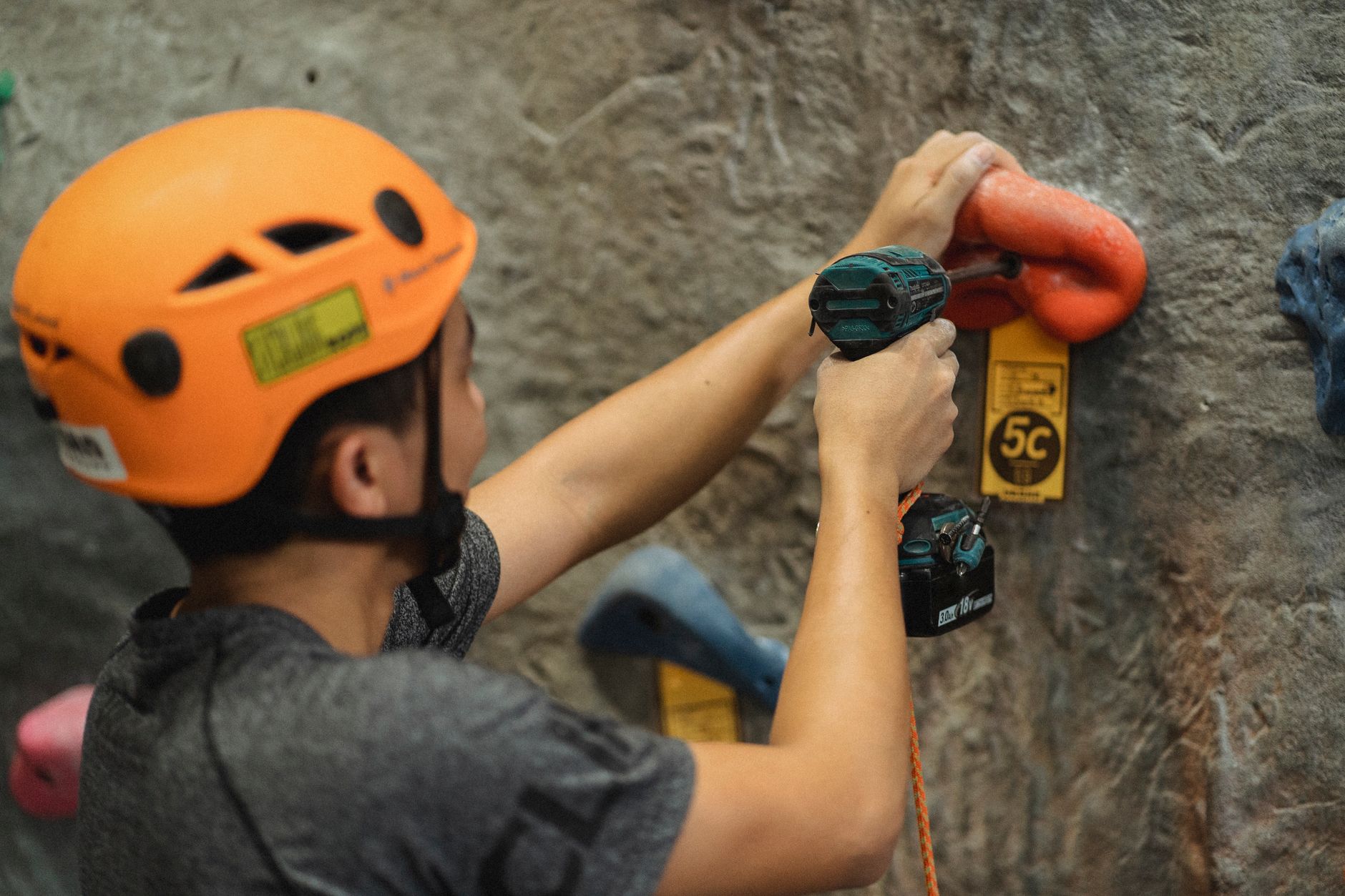 Person drilling into a wall during home installation