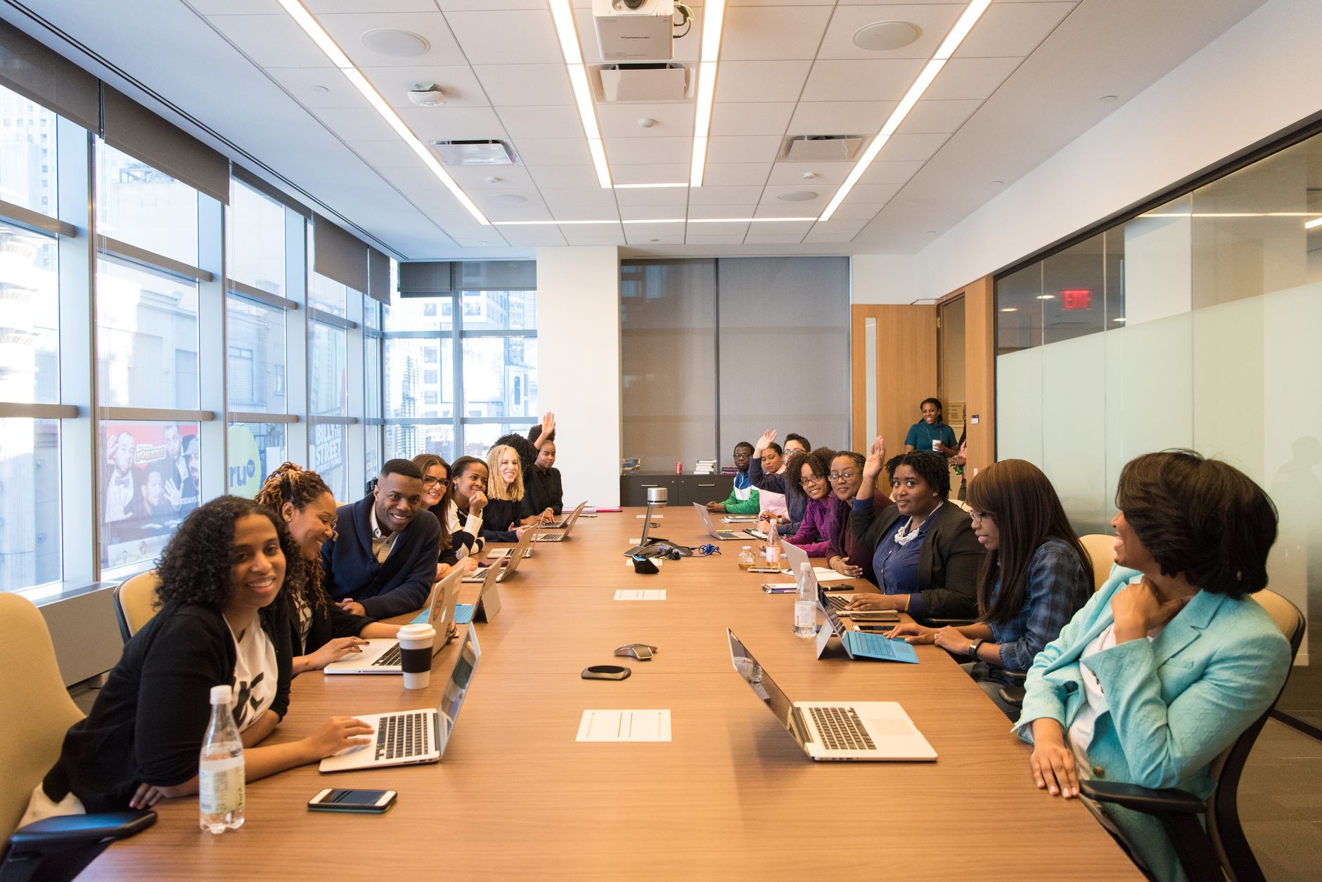 Business professionals in a corporate meeting discussing organizational restructuring