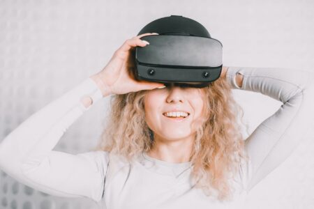 Person wearing a VR headset in a darkened room