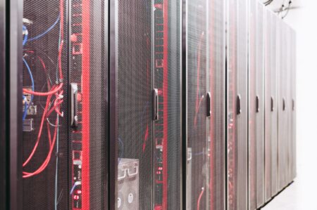 Cornelis Networks Raises $205M, Targets GPU Idle Time Problem Rows of servers inside a large AI data center facility
