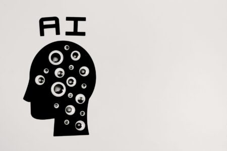 AI Lab Insiders Say Extinction Risk Is Real. Researcher working at a computer terminal surrounded by data screens in a modern AI laboratory