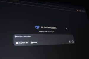 Claude Gets Document Creation and Cowork Tools for Paid Users Person using an AI chat interface on a laptop to create documents