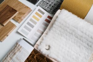 Pinterest teases a new ‘Restyle’ feature that lets you redesign your room with AI A mood board with home decor swatches and room inspiration photos spread on a table