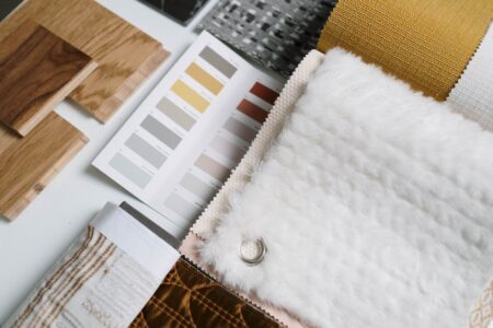 Pinterest teases a new ‘Restyle’ feature that lets you redesign your room with AI A mood board with home decor swatches and room inspiration photos spread on a table