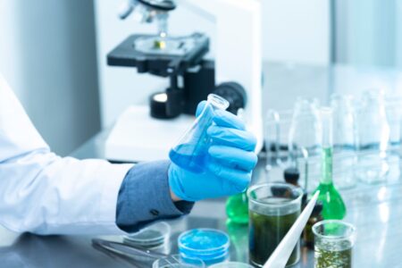 Scientist working in a biosafety laboratory with protective equipment