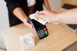 Revolut Tests Face-Scanning Payments at UK Store Checkouts Customer paying at a modern retail checkout counter