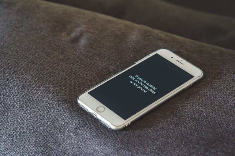 How to get your cut of Apple’s $250 million Siri settlement Person holding a smartphone with a privacy screen, representing mobile data concerns