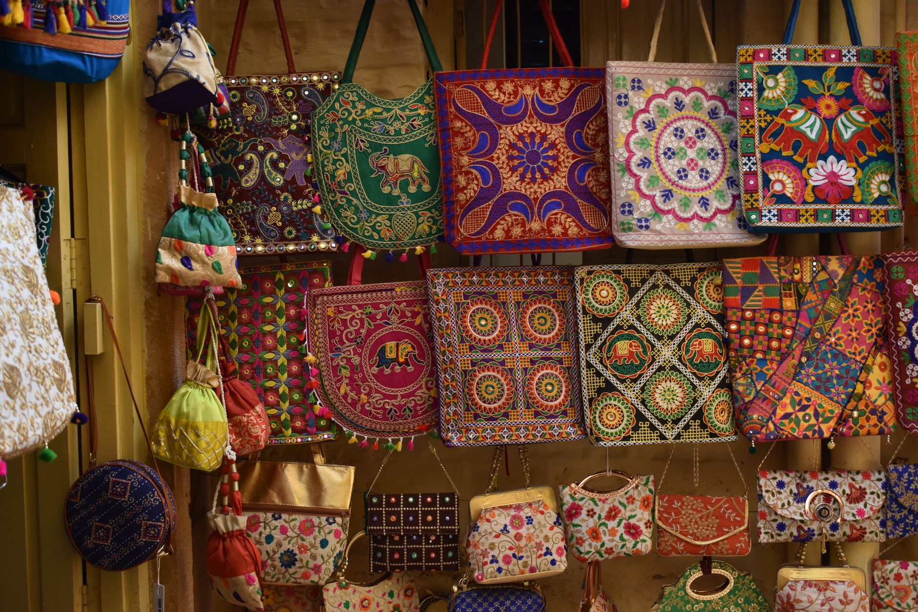 Colorful decorative charms hanging from a bag zipper