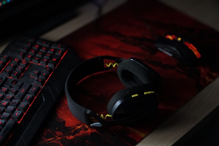 Dolby Atmos for Headphones: What Gamers Actually Get A pair of stereo headphones resting on a gaming desk setup