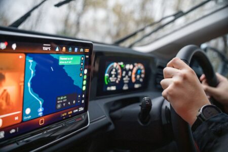 Driver using an Android Auto interface on a car's infotainment touchscreen