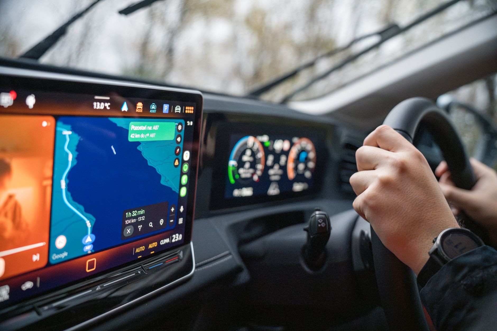 Driver using an Android Auto interface on a car's infotainment touchscreen