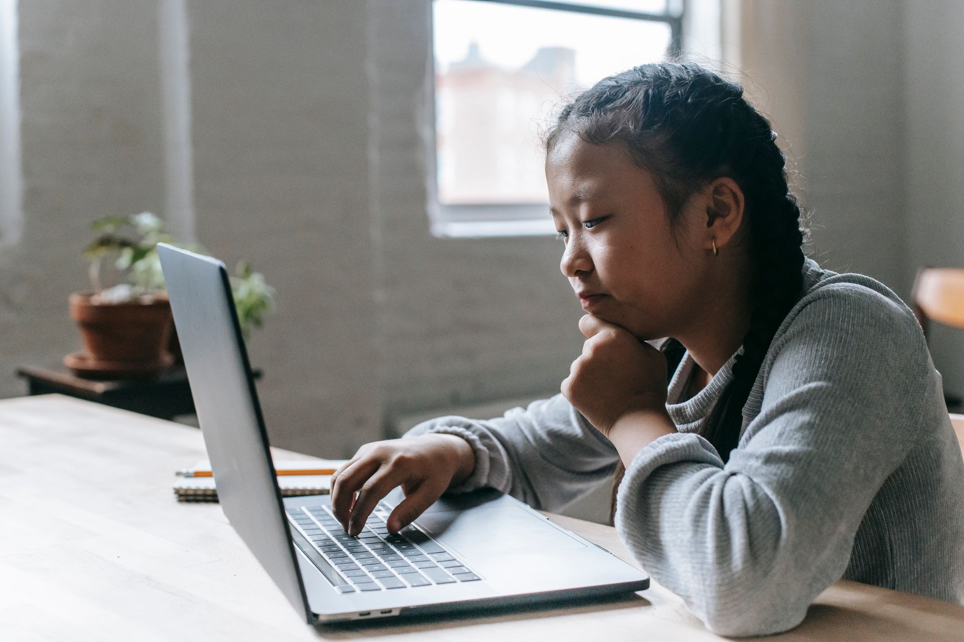 Child using a tablet device with parental supervision in a home setting