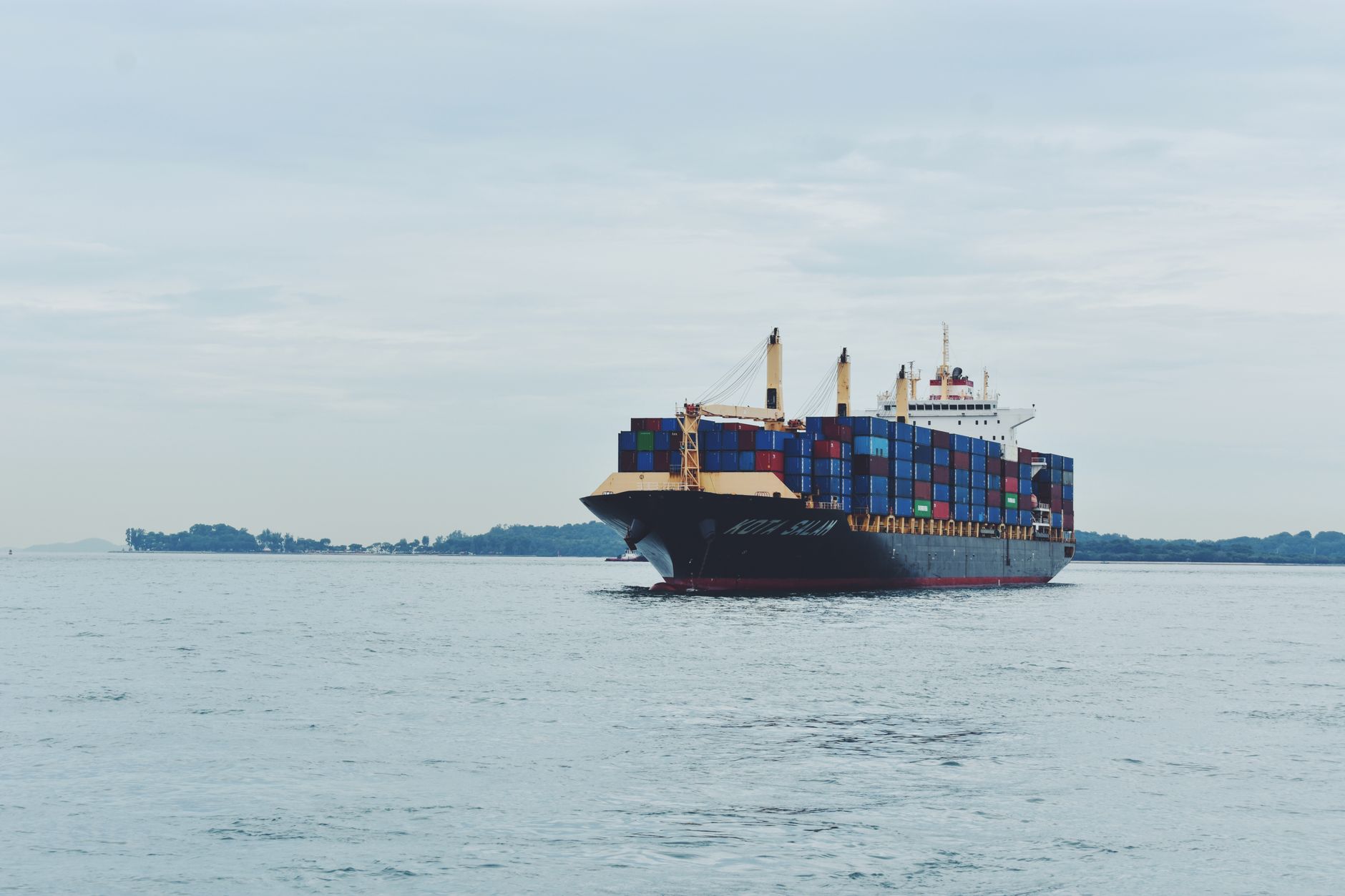 Large cargo ship crossing open ocean waters used for heavy freight transport