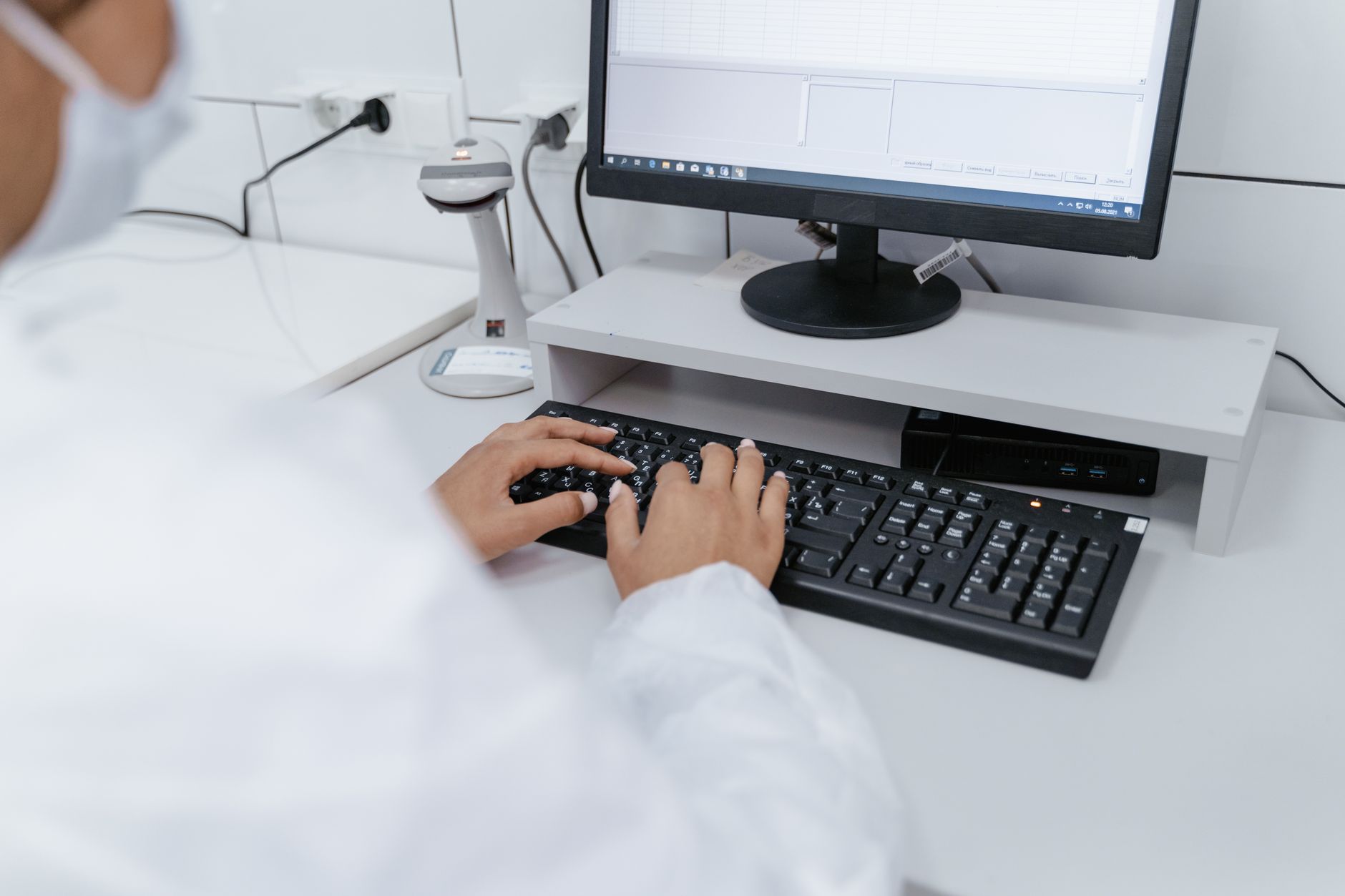 A researcher examining data on a computer monitor in a dimly lit laboratory setting