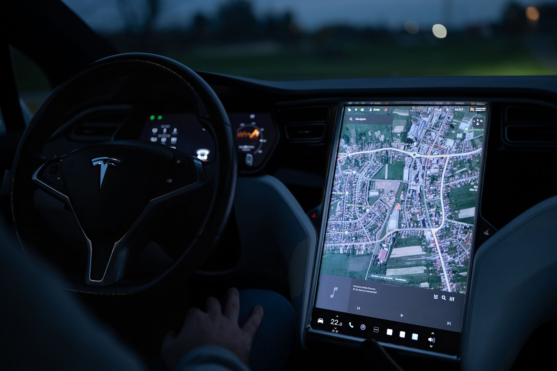 Interior dashboard of a high-end electric vehicle showing digital displays and premium materials