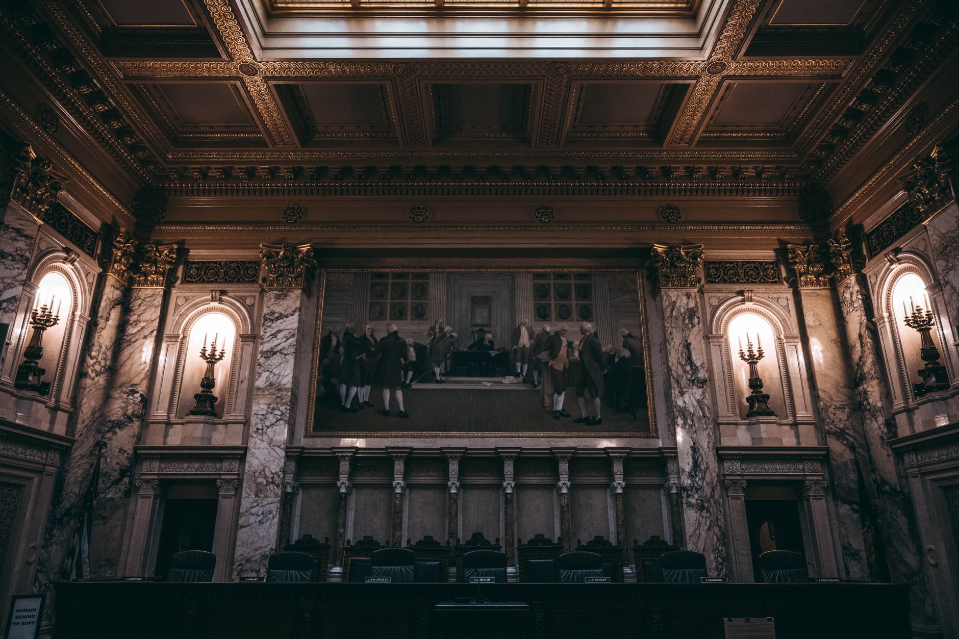 Empty courtroom interior with wooden benches and formal legal setting