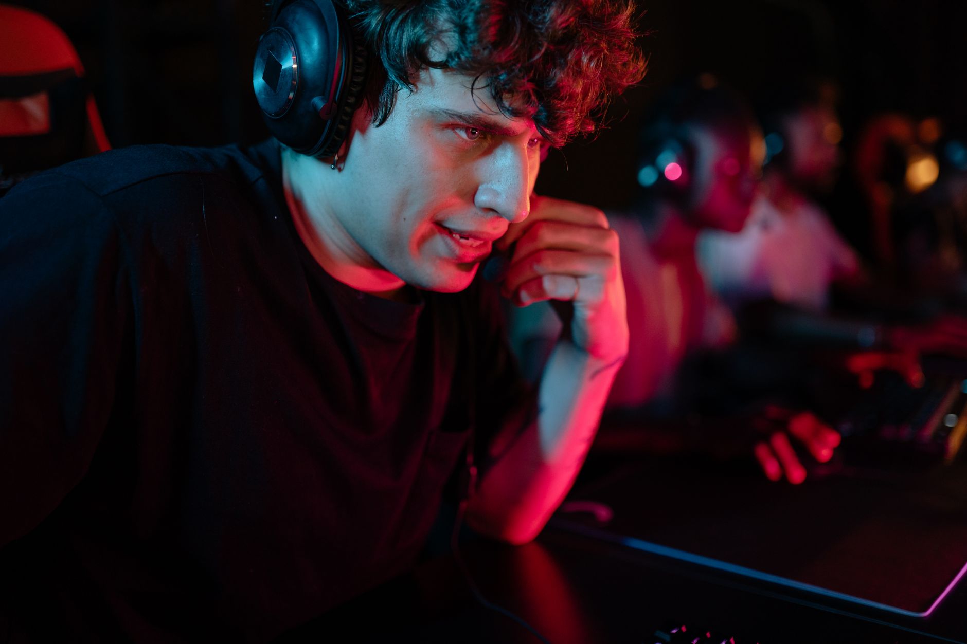 A gamer wearing over-ear headphones during a gaming session