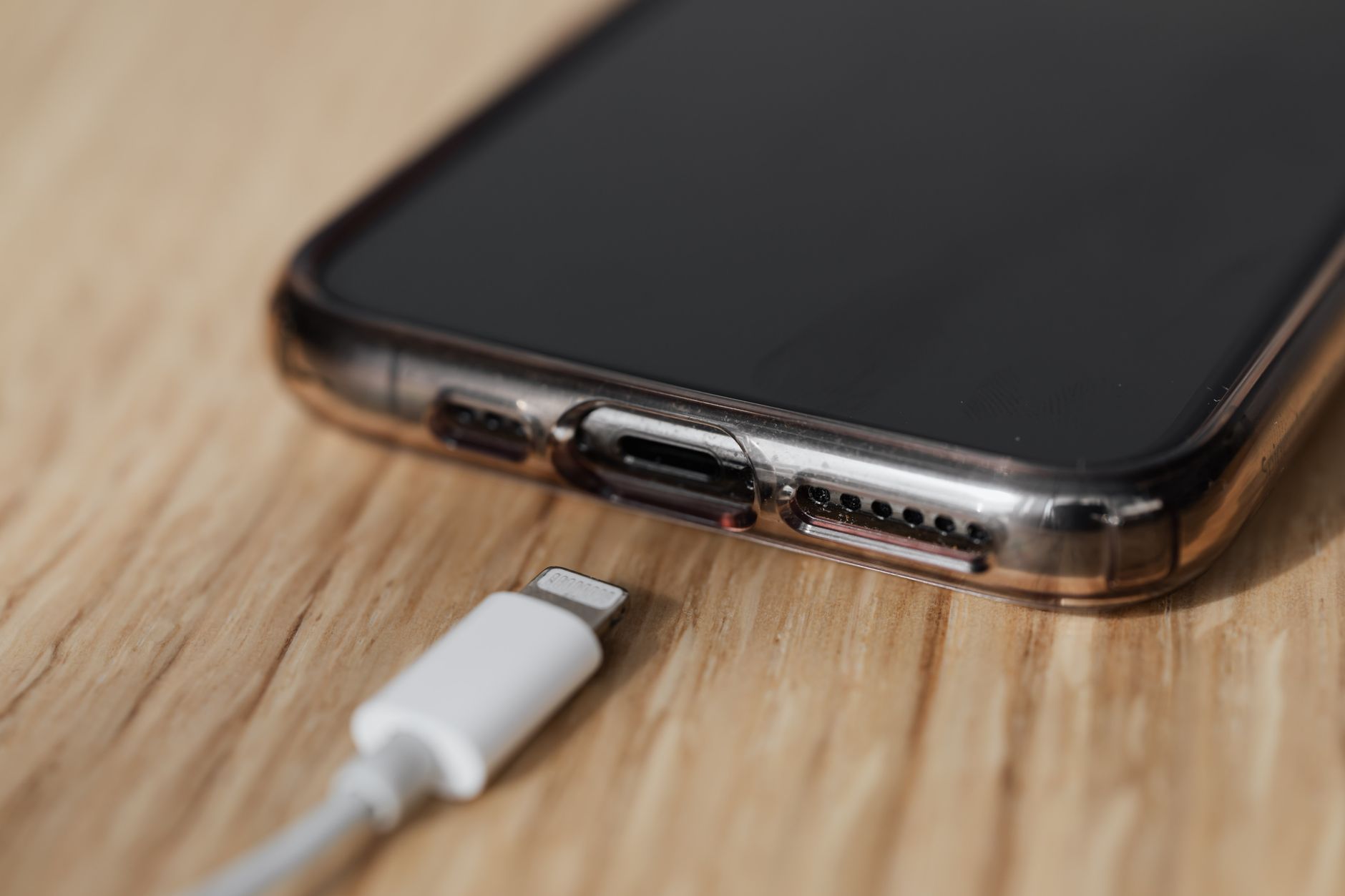 USB-C cable next to a smartphone on a car seat