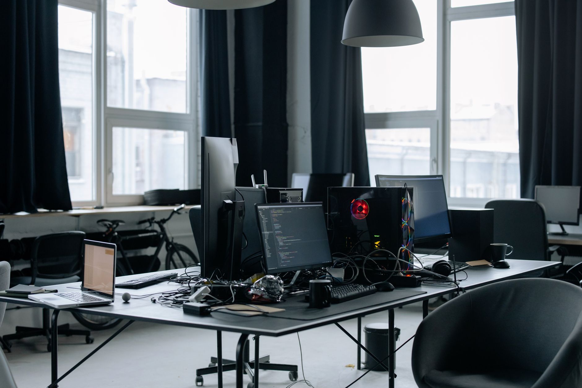 Engineers monitoring infrastructure systems on multiple screens in a control room