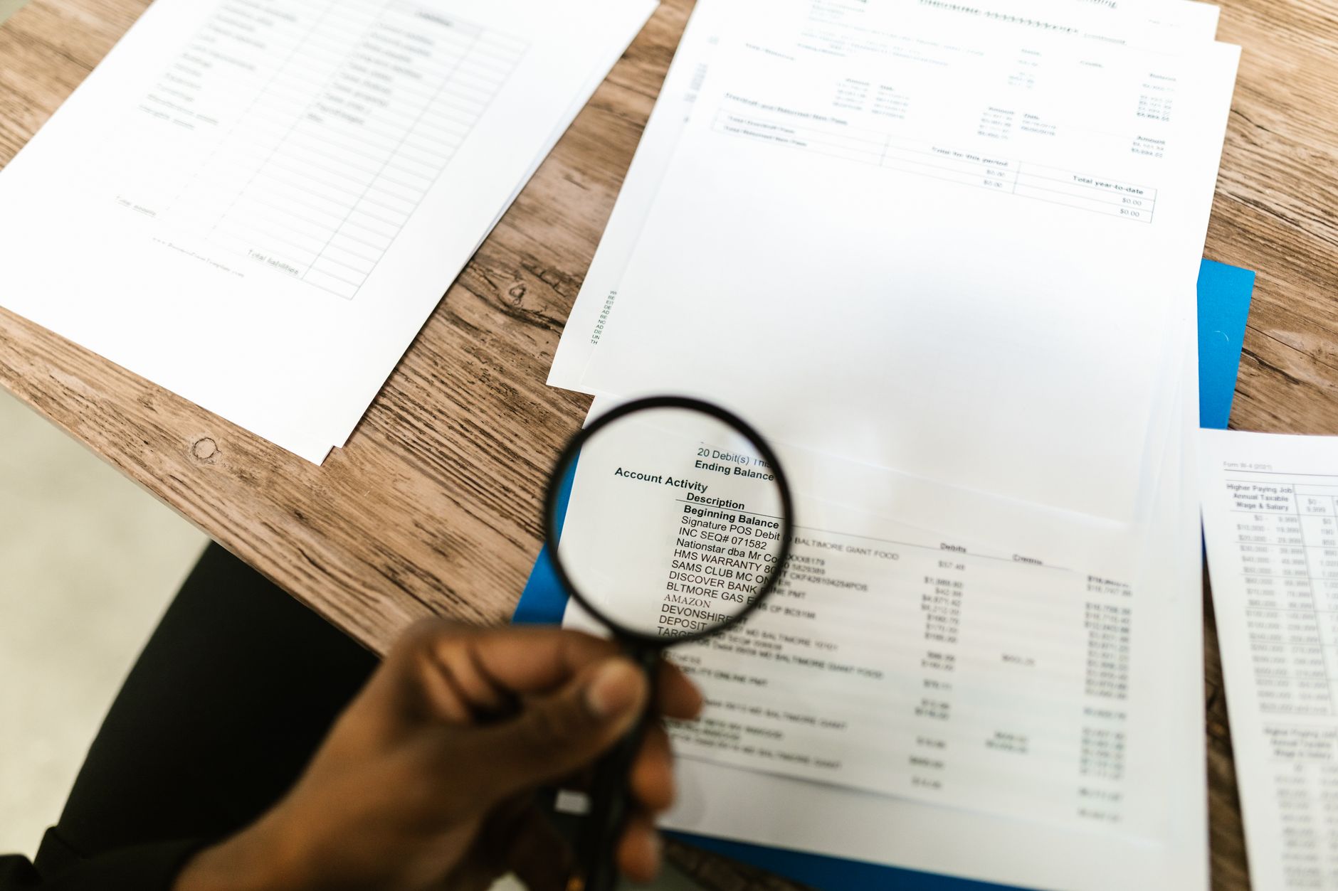 Office worker reviewing documents, representing insurance claims and application verification processes
