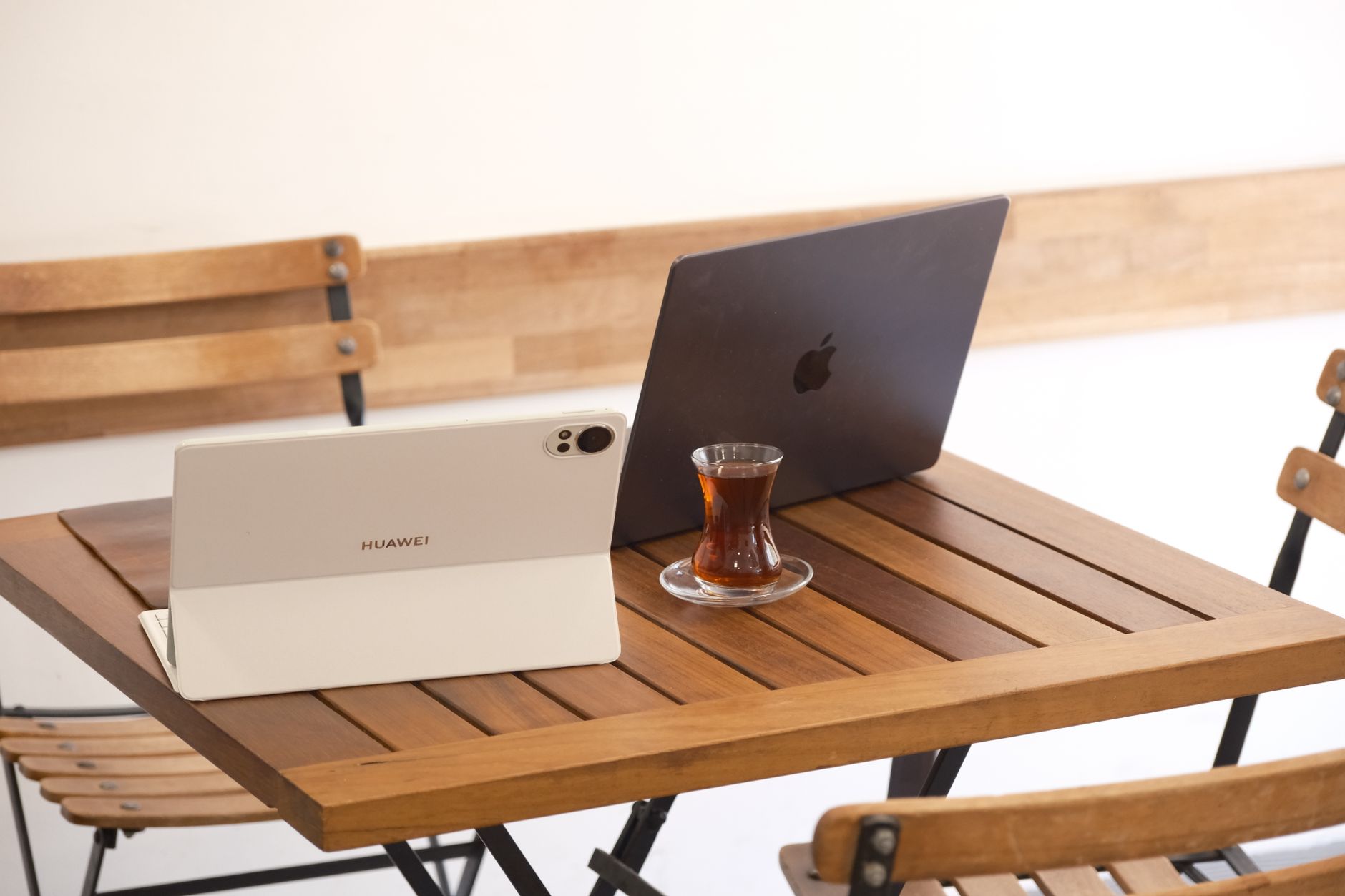 Person working on smartphone at a coffee shop table